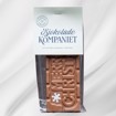 Sjokoladeplate med teksten Merry Christmas! i melk- og karamellsjokolade på hvit bakgrunn