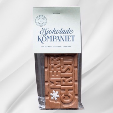 Sjokoladeplate med teksten Merry Christmas! i melk- og karamellsjokolade på hvit bakgrunn